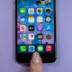 A photo of a thump touching the Home button